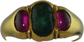 Gold Ring Studded with Red Burmese Rubies and Blue Emerald.