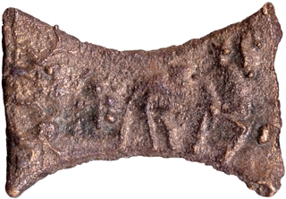 	Unpublished Damru shaped Cast Copper Coin of Kaushambi Region with Swastika and Nandipada Symbols.	