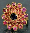 Gold Ring Studded with Red Burmese Rubies and Blue Sapphire.